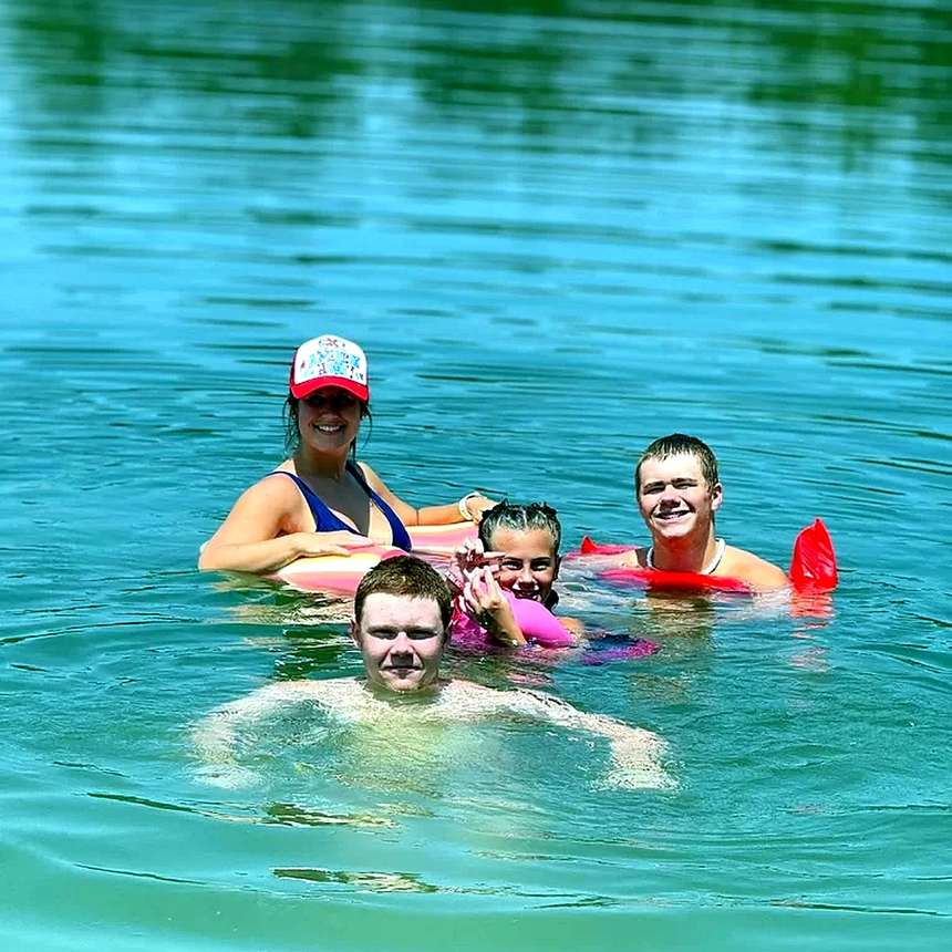 Family swimming together in the lake at Lake LaCroix