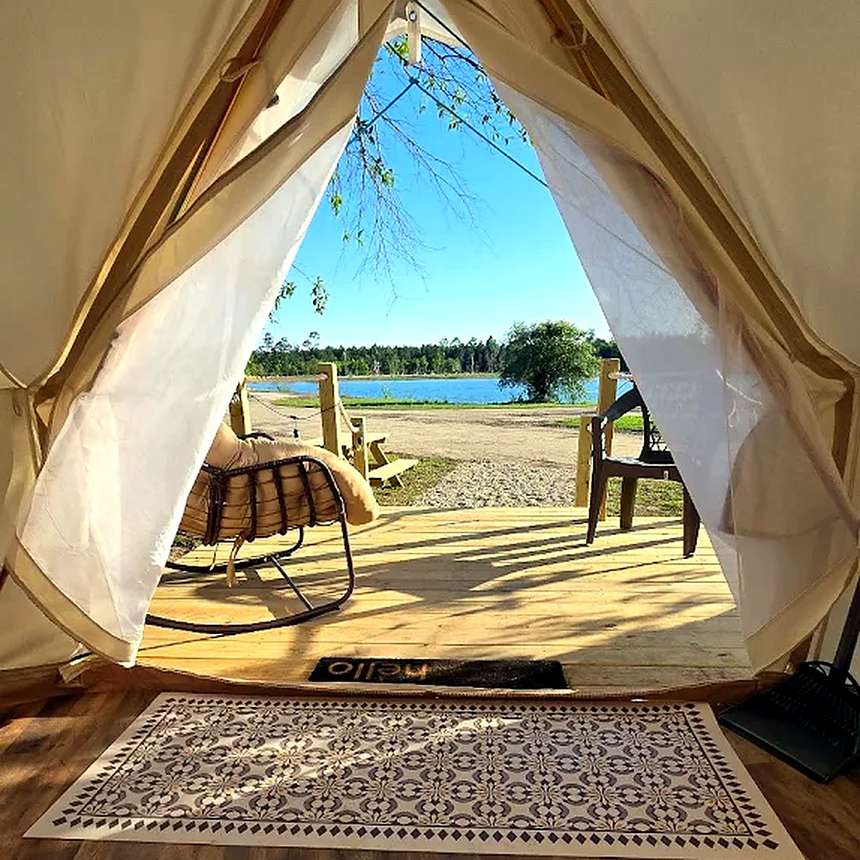 Furnished glamping tent with a lake view at Lake LaCroix RV Resort