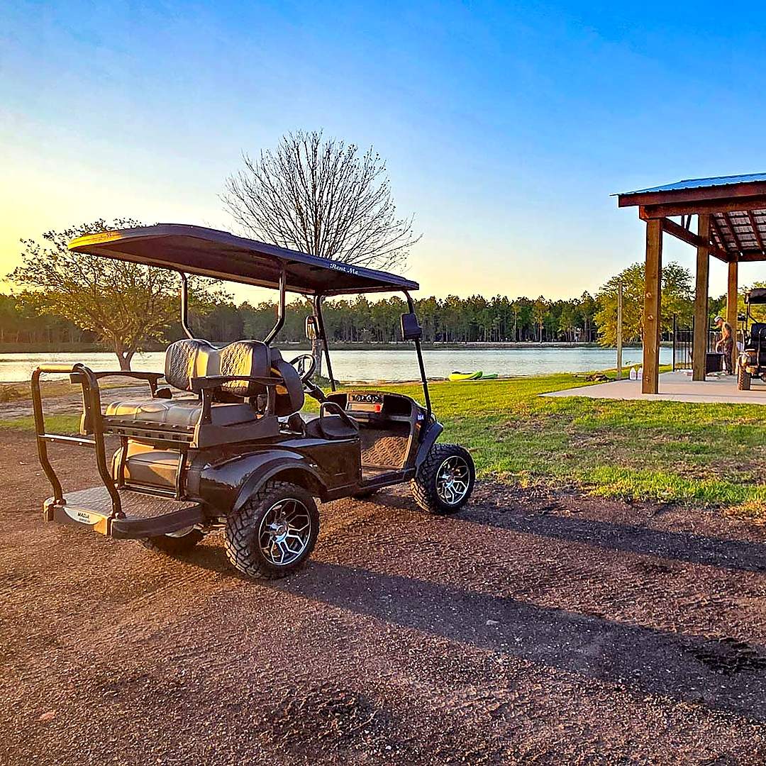 Golf cart by the lake at golden hour at Lake LaCroix RV Resort